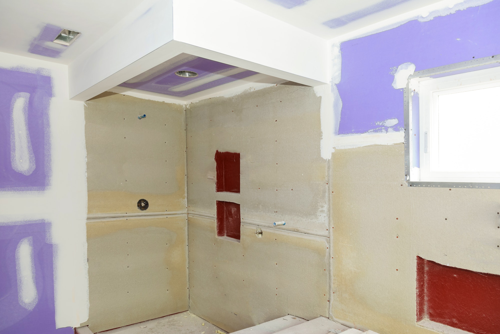 Bathroom remodeling progresses as drywall is smoothed