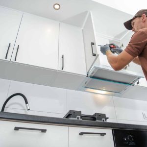 Contractor Worker Assembling of New Apartment Kitchen Cabinets