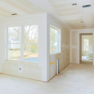Interior construction of housing project with drywall installed and patched without painting applied